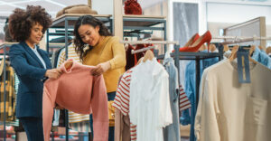 Gen Z shoppers engaging in-store with clothing, reflecting community-driven loyalty experiences.