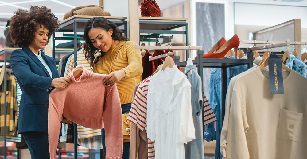 Gen Z shoppers engaging in-store with clothing, reflecting community-driven loyalty experiences.
