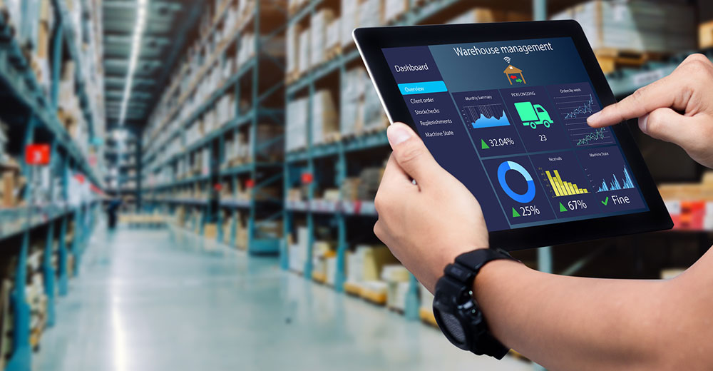 Retail worker uses a tablet to analyze warehouse data and optimize supply chain operations, highlighting how technology helps retailers adapt to tariffs and trade policy shifts.
