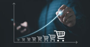A rising graph made of shopping carts illustrating how extended online sales events build momentum and drive higher retail performance over time.