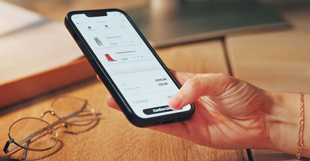 Mobile shopper reviewing cart and confirming purchase on smartphone checkout screen