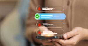 Smartphone displaying multiple scam text warnings alongside a verified message indicator